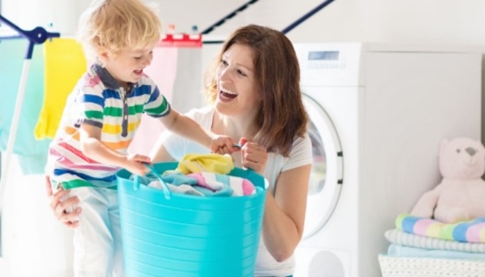 Mom With Child In Laundry Room