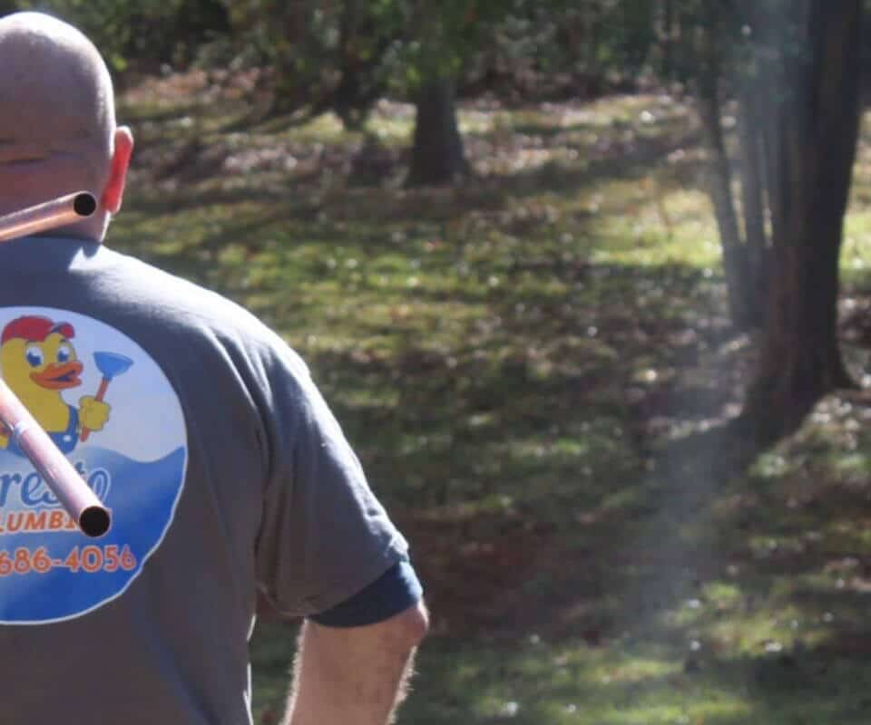 plumber-with-presto-shirt-and-pipes-cropped